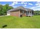 Brick home with attached garage and screened porch on grassy lot at 3950 Chattahoochee Rd, Cumming, GA 30041