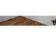 Close-up of pristine hardwood flooring with white baseboards at 3950 Chattahoochee Rd, Cumming, GA 30041
