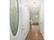 View of the long hallway shows hardwood floors, front door and an open living area at 3950 Chattahoochee Rd, Cumming, GA 30041