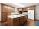 Well-equipped kitchen featuring wooden cabinets, stainless steel appliances, and an island at 3950 Chattahoochee Rd, Cumming, GA 30041