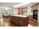 Bright kitchen with a large island, wood cabinets, and a dining area at 3950 Chattahoochee Rd, Cumming, GA 30041