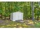 Durable outdoor storage shed with double doors and ramp, nestled in a wooded area at 3950 Chattahoochee Rd, Cumming, GA 30041