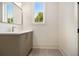 Bathroom featuring a modern vanity, a window, and tiled flooring at 4757 Lake Forrest Drive Northwest Dr, Atlanta, GA 30342