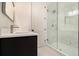 Modern bathroom with black vanity and glass-enclosed shower with marble-look tile at 4757 Lake Forrest Drive Northwest Dr, Atlanta, GA 30342