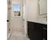Contemporary bathroom with dark vanity, white countertop, and a large framed mirror above at 4757 Lake Forrest Drive Northwest Dr, Atlanta, GA 30342