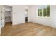 Open bedroom with hardwood floors, large windows, and a view into the closet and bathroom at 4757 Lake Forrest Drive Northwest Dr, Atlanta, GA 30342