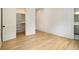 Bedroom featuring an ensuite bathroom, walk-in closet, and sleek hardwood floors at 4757 Lake Forrest Drive Northwest Dr, Atlanta, GA 30342