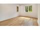 Bright bedroom with two windows providing natural light and gleaming hardwood floors at 4757 Lake Forrest Drive Northwest Dr, Atlanta, GA 30342