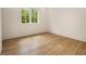 Bright bedroom showcasing hardwood floors and a window with a view of lush greenery at 4757 Lake Forrest Drive Northwest Dr, Atlanta, GA 30342