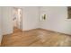 Bedroom with hardwood flooring, and a view of staircase through the doorway at 4757 Lake Forrest Drive Northwest Dr, Atlanta, GA 30342