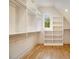 Spacious closet with custom shelving, wooden floors, and a window bringing in natural light at 4757 Lake Forrest Drive Northwest Dr, Atlanta, GA 30342