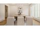 Dining area with modern chairs and neutral tones, lit by an elegant chandelier and natural light at 4757 Lake Forrest Drive Northwest Dr, Atlanta, GA 30342