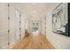 Hallway with beautiful artwork, neutral colors, and hardwood floors throughout the home at 4757 Lake Forrest Drive Northwest Dr, Atlanta, GA 30342