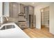 Modern kitchen with stainless steel appliances, grey cabinets, and ample counter space with pantry at 4757 Lake Forrest Drive Northwest Dr, Atlanta, GA 30342