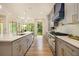 Modern kitchen with gray cabinets, stainless steel appliances, a central island and a view of nature at 4757 Lake Forrest Drive Northwest Dr, Atlanta, GA 30342