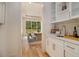 This wet bar features white cabinets, a marble countertop, and stainless steel appliances at 4757 Lake Forrest Drive Northwest Dr, Atlanta, GA 30342
