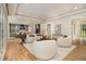An open-concept living room with a view into the kitchen, featuring modern decor and large windows at 4757 Lake Forrest Drive Northwest Dr, Atlanta, GA 30342