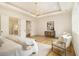 Large main bedroom with hardwood floors, tray ceilings, statement lighting fixture, and a seating area at 4757 Lake Forrest Drive Northwest Dr, Atlanta, GA 30342