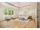 Bright and spacious main bedroom with large windows, hardwood floors, tray ceiling and designer lighting at 4757 Lake Forrest Drive Northwest Dr, Atlanta, GA 30342