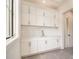 Bright mudroom features white cabinets, a sink, and a window providing natural light at 4757 Lake Forrest Drive Northwest Dr, Atlanta, GA 30342