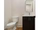 Half bathroom with a modern toilet, dark wood vanity, and a rectangular mirror at 4757 Lake Forrest Drive Northwest Dr, Atlanta, GA 30342
