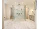 Large frameless glass walk-in shower with three shower heads and a large tile surround at 4757 Lake Forrest Drive Northwest Dr, Atlanta, GA 30342