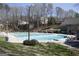 Community swimming pool surrounded by lush green trees and features plenty of space for relaxation at 4757 Lake Forrest Nw Dr, Atlanta, GA 30342