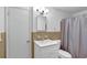 Clean and functional bathroom with a white vanity and shower with curtain at 4774 Saint Bernard Sw Dr, Lilburn, GA 30047