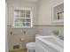 Bright bathroom with patterned tile flooring and classic fixtures with natural light at 4774 Saint Bernard Sw Dr, Lilburn, GA 30047