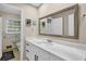 Updated bathroom features a large vanity, stylish mirror, and lots of natural light at 4774 Saint Bernard Sw Dr, Lilburn, GA 30047