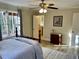 Cozy bedroom featuring hardwood floors, natural light, and tasteful decor at 4774 Saint Bernard Sw Dr, Lilburn, GA 30047