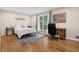 Cozy bedroom features hardwood floors, neutral paint, large windows, and plenty of natural light at 4774 Saint Bernard Sw Dr, Lilburn, GA 30047