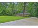 Brick ranch house with a well-maintained lawn and long driveway with mature trees at 4774 Saint Bernard Sw Dr, Lilburn, GA 30047