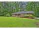 Charming brick ranch home featuring a well-manicured lawn and mature trees at 4774 Saint Bernard Sw Dr, Lilburn, GA 30047