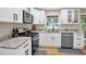 Bright kitchen features granite countertops, stainless steel appliances, and white cabinetry at 4774 Saint Bernard Sw Dr, Lilburn, GA 30047