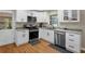 Bright kitchen features granite countertops, stainless steel appliances, and white cabinetry at 4774 Saint Bernard Sw Dr, Lilburn, GA 30047