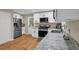 Modern kitchen featuring granite countertops, stainless steel appliances, and white cabinetry at 4774 Saint Bernard Sw Dr, Lilburn, GA 30047