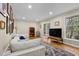 Comfortable living room with hardwood floors, fireplace, and sliding door leading to the deck at 4774 Saint Bernard Sw Dr, Lilburn, GA 30047