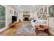 Open living room features a cozy fireplace, hardwood flooring, and plenty of natural light at 4774 Saint Bernard Sw Dr, Lilburn, GA 30047
