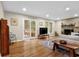 Bright living room with hardwood floors, fireplace, and sliding glass doors to deck at 4774 Saint Bernard Sw Dr, Lilburn, GA 30047