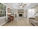 Cozy living room featuring a brick fireplace, wood-look floors, and natural light from large windows at 4774 Saint Bernard Sw Dr, Lilburn, GA 30047