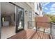 View from the outdoor balcony with black railings and hardwood flooring leading to the bright interior space at 2333 Mason Dr # D26, Atlanta, GA 30316