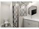 Bathroom with shower, geometric tiles, white vanity and modern mirror at 2333 Mason Dr # D26, Atlanta, GA 30316