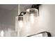 Close-up of modern bathroom lighting fixture with seeded glass shades at 2333 Mason Dr # D26, Atlanta, GA 30316