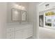 Bright bathroom featuring vanity with storage and open doorway to bedroom at 2333 Mason Dr # D26, Atlanta, GA 30316