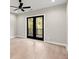 Bedroom featuring hardwood flooring, ceiling fan, and private balcony with black metal railings at 2333 Mason Dr # D26, Atlanta, GA 30316