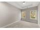 Bright, neutral bedroom with tray ceiling and ample natural light from two large windows at 2333 Mason Dr # D26, Atlanta, GA 30316