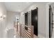 Hallway with wooden railing and sliding black barn doors leading to other rooms in the home at 2333 Mason Dr # D26, Atlanta, GA 30316