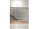Hallway with wood floor, white marble floor, and horizontal black metal railing at 2333 Mason Dr # D26, Atlanta, GA 30316