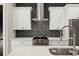 Close-up of modern kitchen with white cabinets, stainless appliances, and patterned backsplash at 2333 Mason Dr # D26, Atlanta, GA 30316